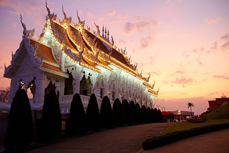 a building that has a lot of lights on it, by Shen Che-Tsai, shutterstock, thai temple, soft morning light, white, beutiful!