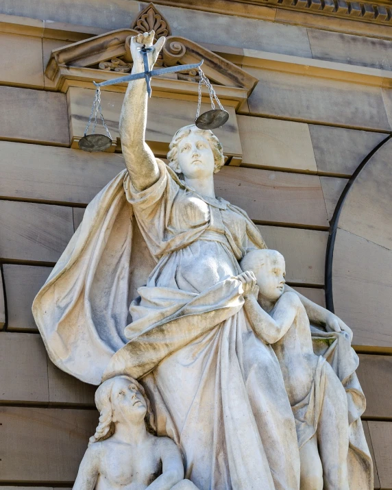 a statue that is on the side of a building, a statue, by John Murdoch, shutterstock, courtroom, goddess. extremely high detail, crimes, family photo