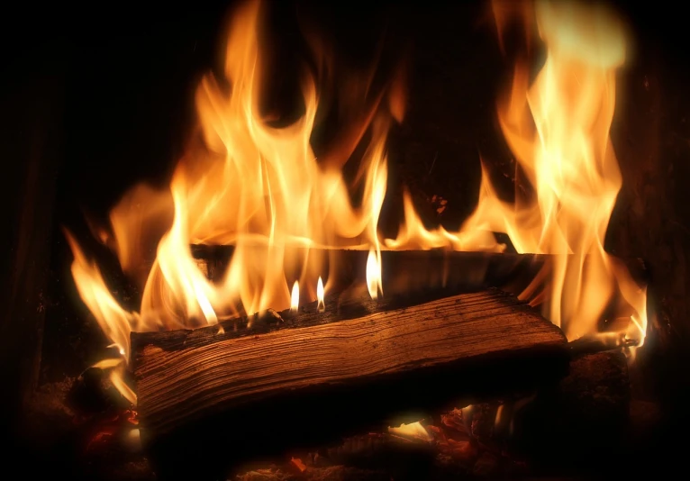 a close up of a fire burning in a fireplace, a picture, by Rodney Joseph Burn, hd wallpaper, extreme log shot, istockphoto, youtube video screenshot