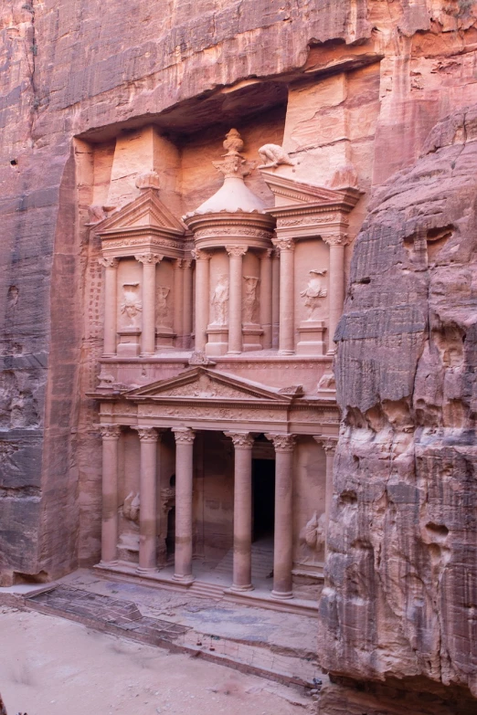 a horse that is standing in front of a building, a portrait, an extremely large cave, red sandstone natural sculptures, roman pillars, high angle vertical