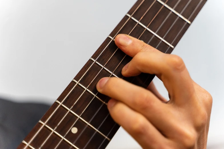 a close up of a person playing a guitar, by Ottó Baditz, only five fingers, vertical lines, webbing, kazuma kaneko