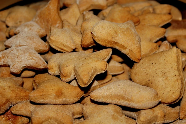 a bowl full of cookies sitting on top of a table, inspired by Béla Kondor, pixabay, figuration libre, animal - shaped bread, winged wolves, closeup - view, in triangular formation