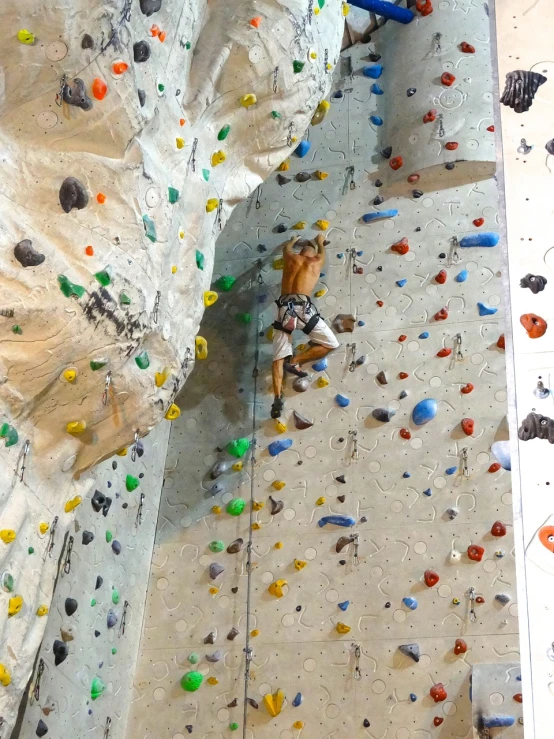 a close up of a person on a climbing wall, a photo, figuration libre, usa-sep 20, inside a tall vetical room, white wall complex, very impressive