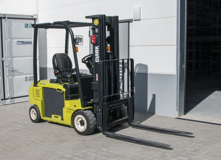 a yellow fork truck parked in front of a building, battery, with a roof rack, doruk erdem, green