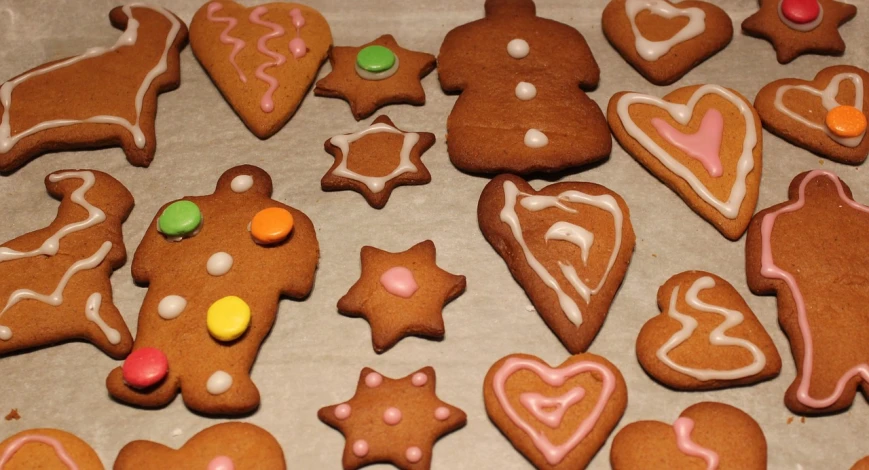 a table topped with lots of cookies covered in icing, by Ödön Márffy, hr ginger, unedited, contour, warm coloured