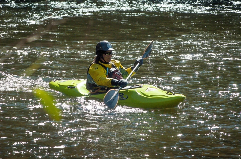 a person in a kayak in a body of water, by Tom Carapic, flickr, with yellow cloths, cahaba river alabama, jester, training