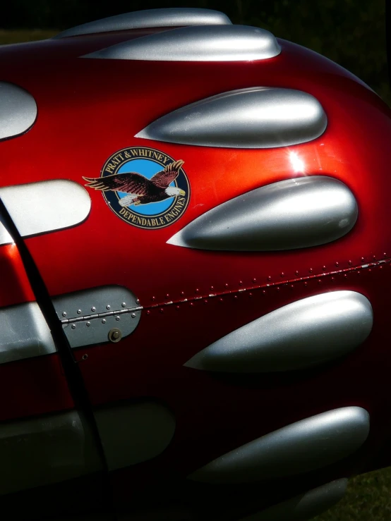 a close up of a shiny red motorcycle, by Howard Butterworth, flickr, photorealism, panavia tornado replica, emblem, a car, long weasel