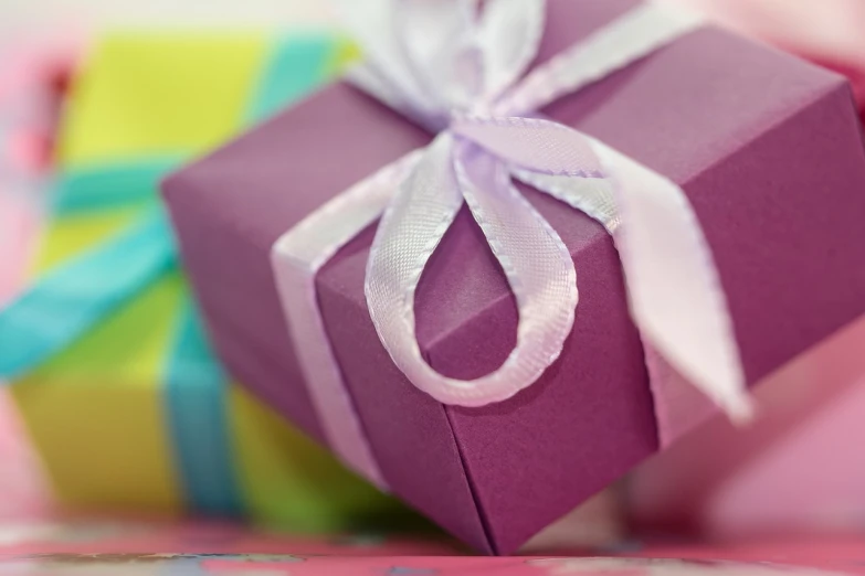 a purple gift box sitting on top of a table, by Alice Mason, pixabay, close up half body shot, karim rashid, pastels colours, profile close-up view