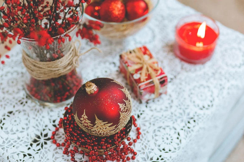 a red christmas ornament sitting on top of a table, a picture, by Maksimilijan Vanka, pexels, centerpiece, red lace, ceramic, jovana rikalo