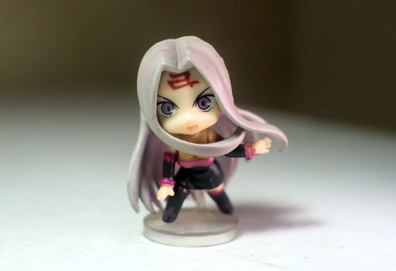 a close up of a figurine on a table, inspired by INO, flickr, haruno sakura, chibi proportions, girl silver ponytail hair, threatening pose