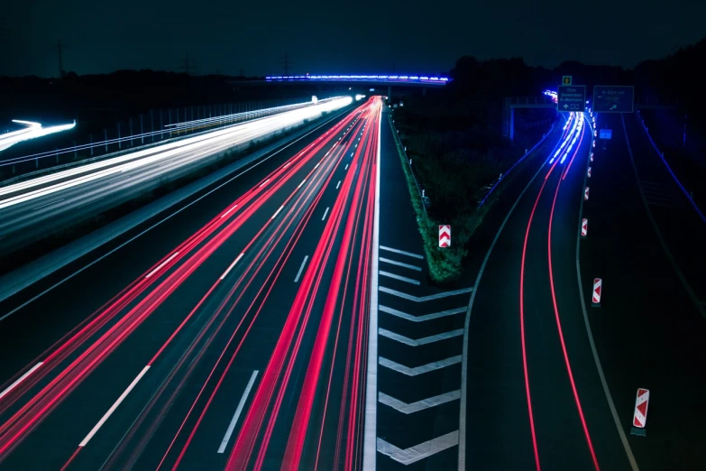 a highway filled with lots of traffic at night, a picture, by Thomas Häfner, lightpainting luminescent, blue and red lighting, istock, stock photo