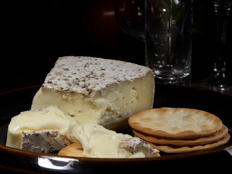 a plate of cheese and crackers on a table, by Tom Carapic, 1 2 0 mm macro, dapple, 3/4 portrait, silky