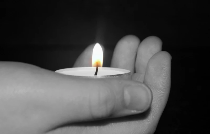 a person holding a lit candle in their hand, a black and white photo, saving the day again, portlet photo, enhanced photo, beautiful photo