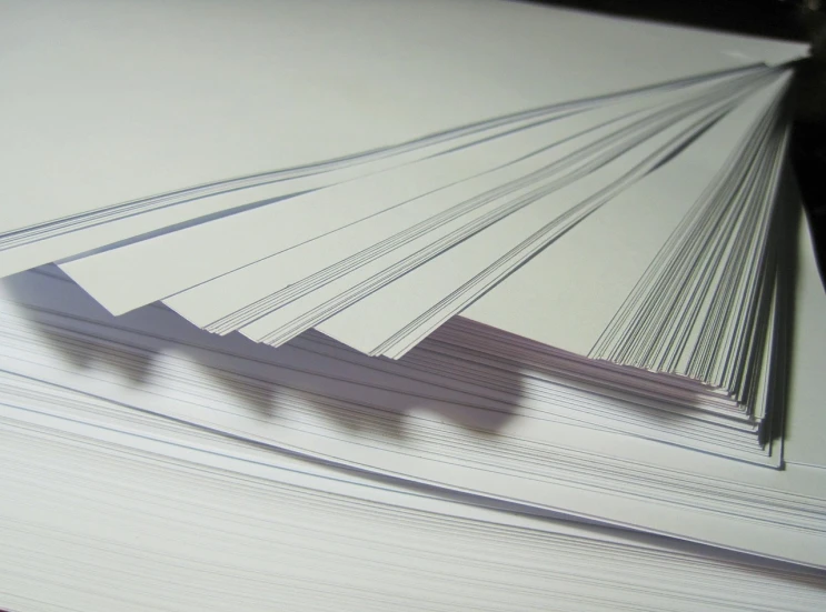 a stack of white paper sitting on top of a table, a photocopy, pexels, process art, thin long fine lines, full colour, wallpaper - 1 0 2 4, pictured from the shoulders up