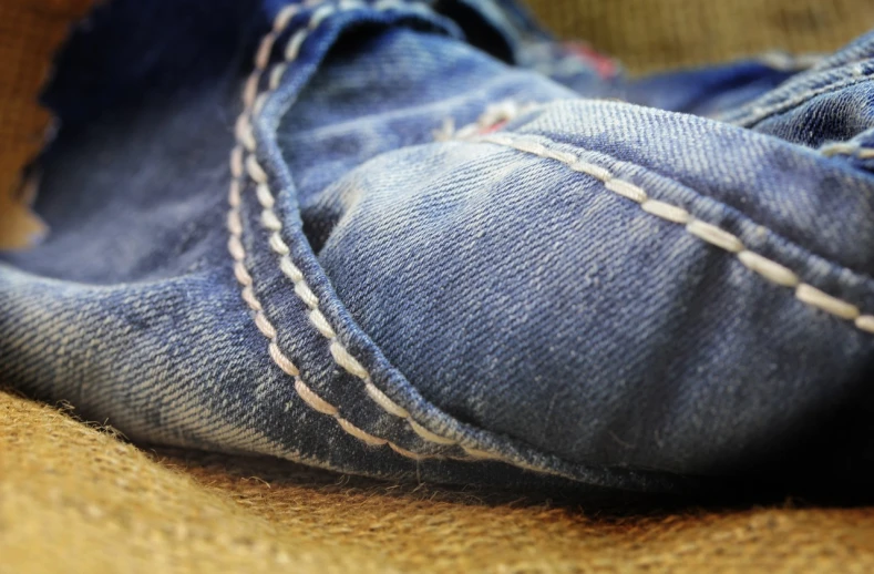 a close up of a pair of blue jeans, by Adam Manyoki, happening, hand made, detailed surroundings, high details photo