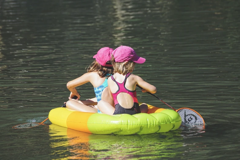 a couple of girls riding on top of an inflatable raft, a picture, by Robert Childress, pexels, mini lake, high res photo, chalk, with straw hat