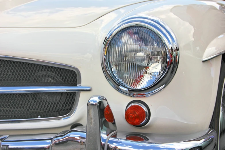 a close up of the front end of a white car, by Jim Nelson, pexels, photorealism, retro lights, convertable, halogen, enamel