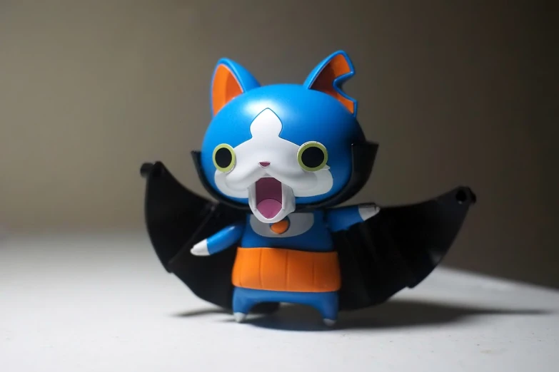 a close up of a figurine of a cat, a picture, by Hiroyuki Tajima, flickr, an anime nendoroid of son goku, banshee, angry batman, blue!! with orange details