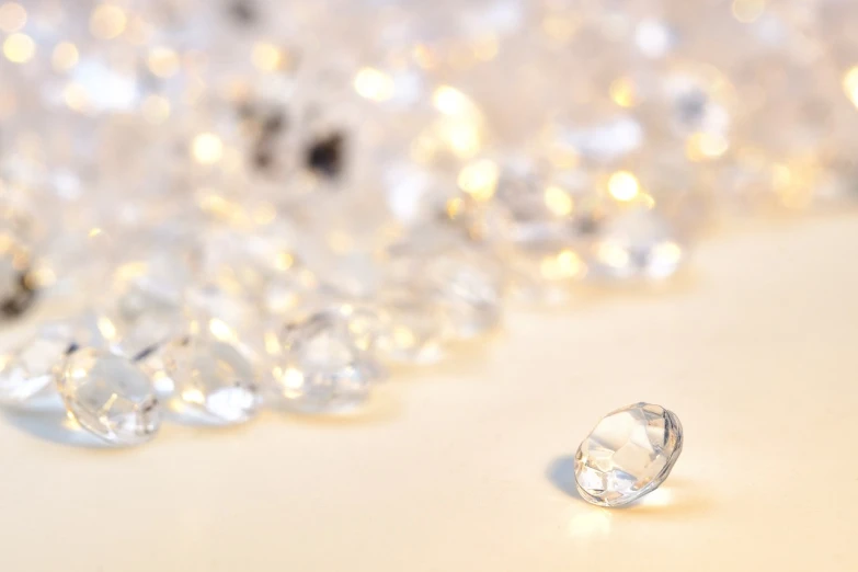 a bunch of diamonds sitting on top of a table, a picture, by Maeda Masao, transparent droplets, miniature product photo, pearlescent white, the background is white