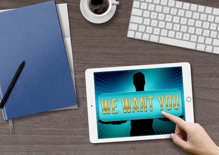 a person holding a tablet with the words we want you on it, a digital rendering, images on the sales website, interview, taking from above, wanted poster