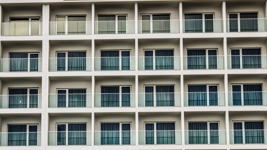 a large white building with many windows and balconies, a photo, inspired by Andreas Gursky, unsplash, hotel room, aruba, f / 1. 9 6. 8 1 mm iso 4 0, usa-sep 20