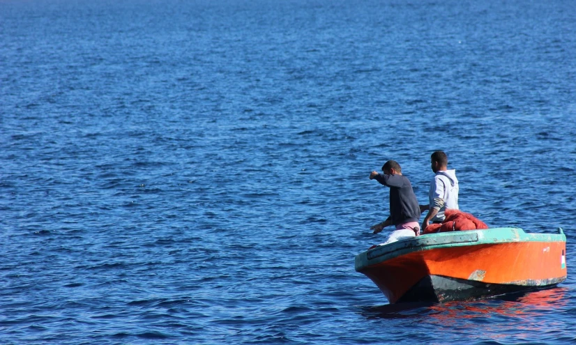 a couple of people on a small boat in the water, by Richard Carline, flickr, hurufiyya, crossing the blue horizon, afar, watch photo, flash photo