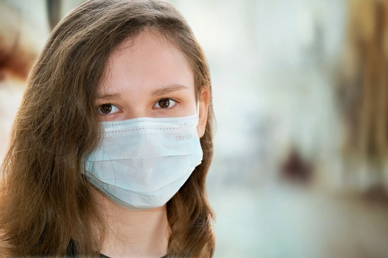 a close up of a person wearing a face mask, a picture, shutterstock, teenager girl, sterile background, girl with brown hair, hospital