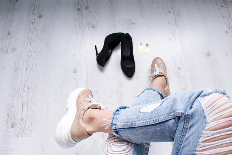 a person standing on a wooden floor next to a pair of shoes, by Zofia Stryjenska, tumblr, ripped jeans, beige colors, platforms, fear of god style