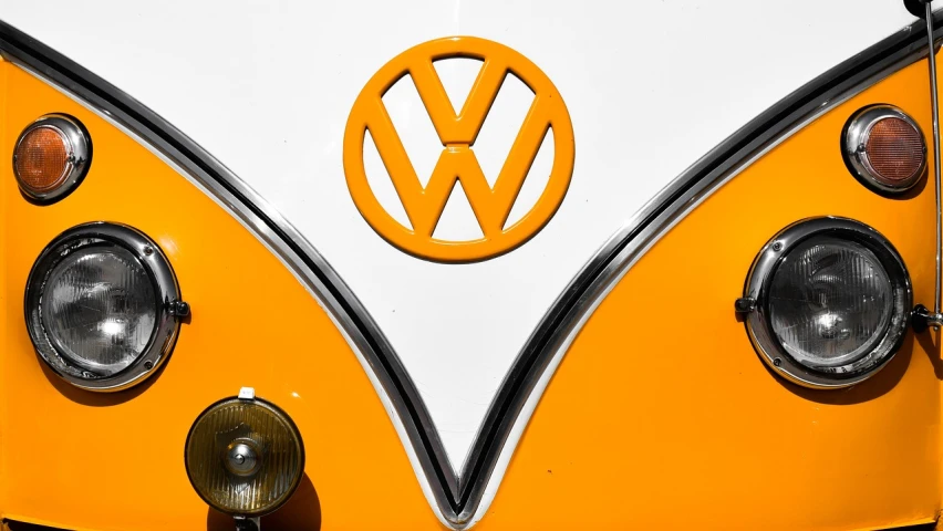 a close up of a yellow and white vw bus, by Matthias Weischer, orange gi, trademarks and symbols, colors orange, 🦩🪐🐞👩🏻🦳