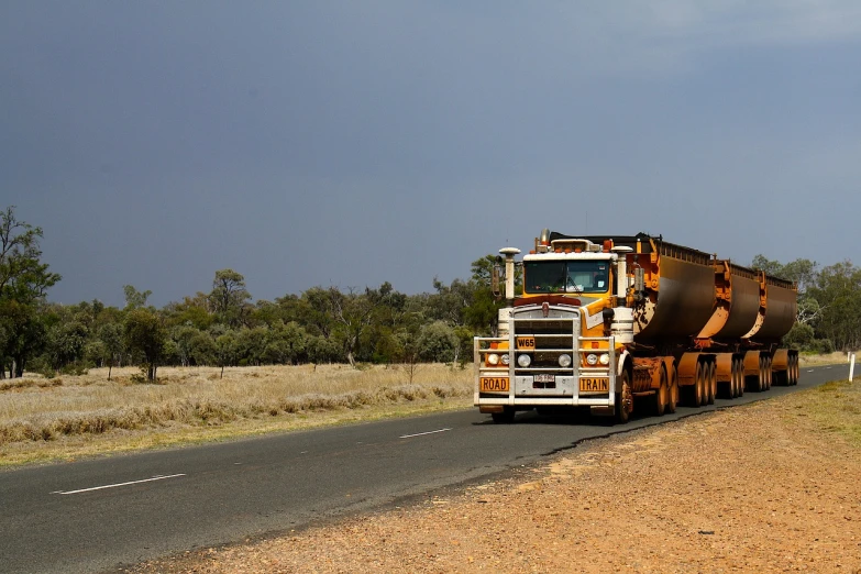 a truck that is sitting on the side of the road, by Dave Allsop, flickr, on a hot australian day, heavy grain, hivis, shaded