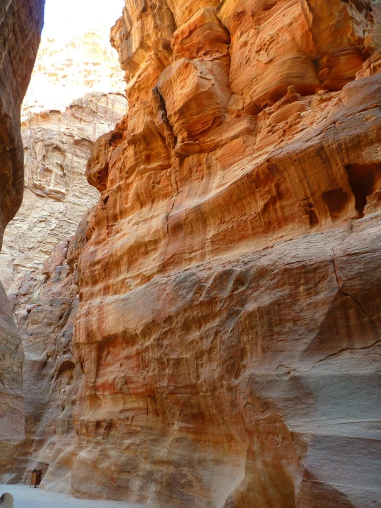 a person riding a horse through a canyon, by Linda Sutton, les nabis, jordan, highly detailed rock structures, dof narrow, striations
