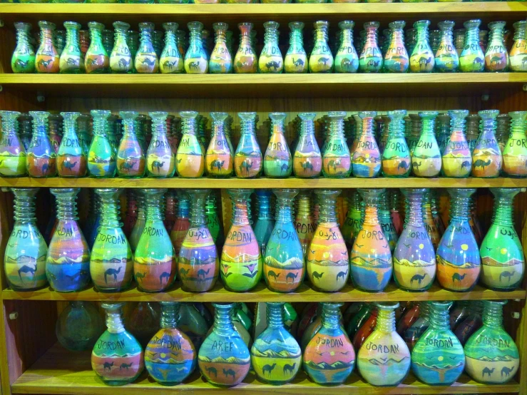 a shelf filled with lots of colorful vases, chalk art, flickr, an amusement park in old egypt, slimy fluid liquid, photo taken on a nikon, marbling