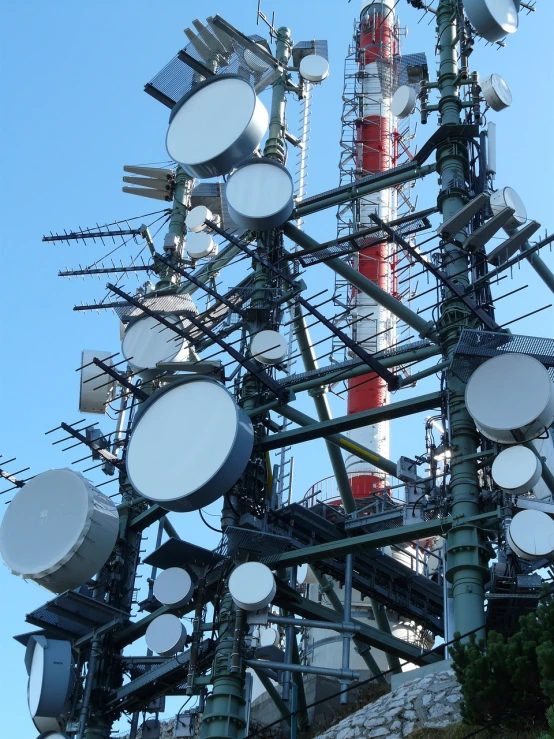 a tower that has many different types of cell phones on it, by Erwin Bowien, shutterstock, large antennae, monitor, set photo, cables and tubes