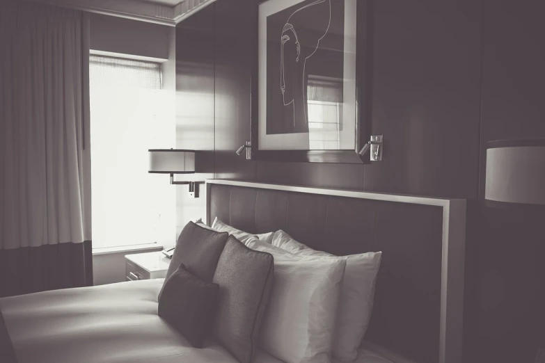 a black and white photo of a bed in a hotel room, a black and white photo, pexels, visual art, luxury condo interior, smooth panelling, vintage color, high details photo