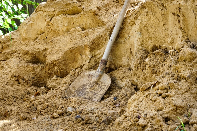 a shovel sitting on top of a pile of dirt, a photo, figuration libre, sandstone, very sharp photo, outdoor photo, detailed zoom photo