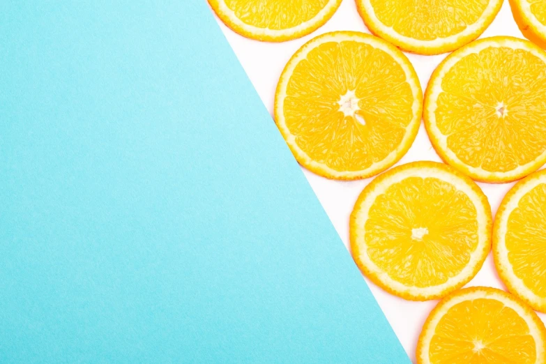 a close up of sliced oranges on a blue and white background, by Joseph-Marie Vien, trending on unsplash, postminimalism, yellow and cyan color palette, background image, on a yellow canva, knolling