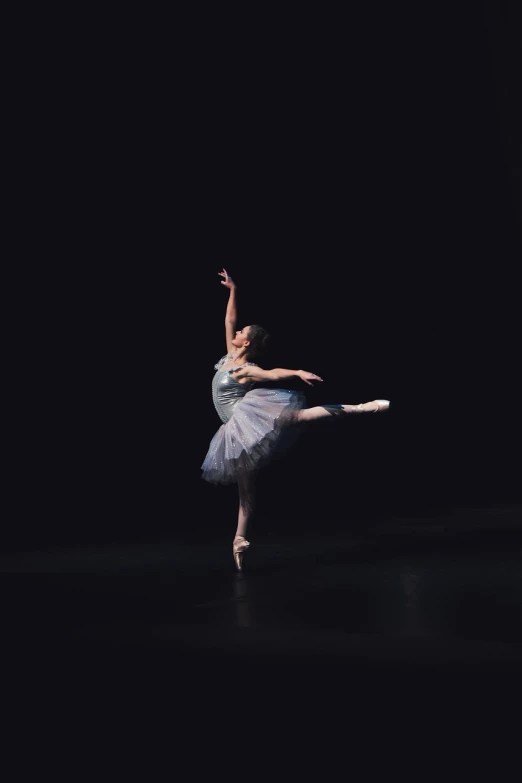 a woman in a white dress is standing in the dark, by Elizabeth Polunin, arabesque, concert, blue toned, having a great time, wearing a pink tutu