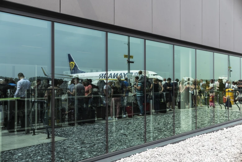 a large passenger jet sitting on top of an airport tarmac, a photo, by Alexander Fedosav, bauhaus, tourists in background, paler. millions of glass-walled, 2 0 2 2 photo, summer 2016