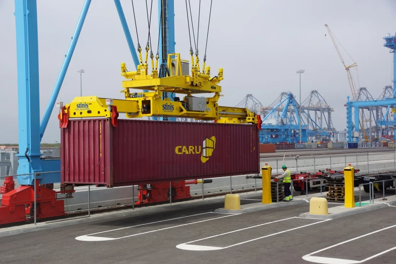 a crane is lifting a container onto a truck, by Matt Cavotta, flickr, high res photo, california, on ship, caroline gariba