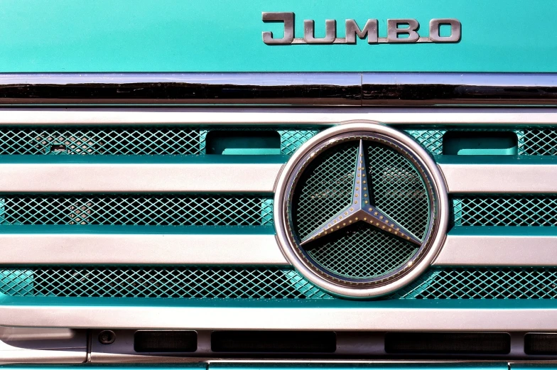 a close up of a mercedes emblem on a truck, a stock photo, by Jürg Kreienbühl, hyperrealism, turquoise color scheme, thick lines, what a bumbler!, jamie reid