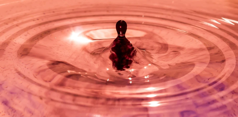 a close up of a spoon in a bowl of water, a picture, by Jan Rustem, precisionism, red and purple, meditation, toy photography, whirling