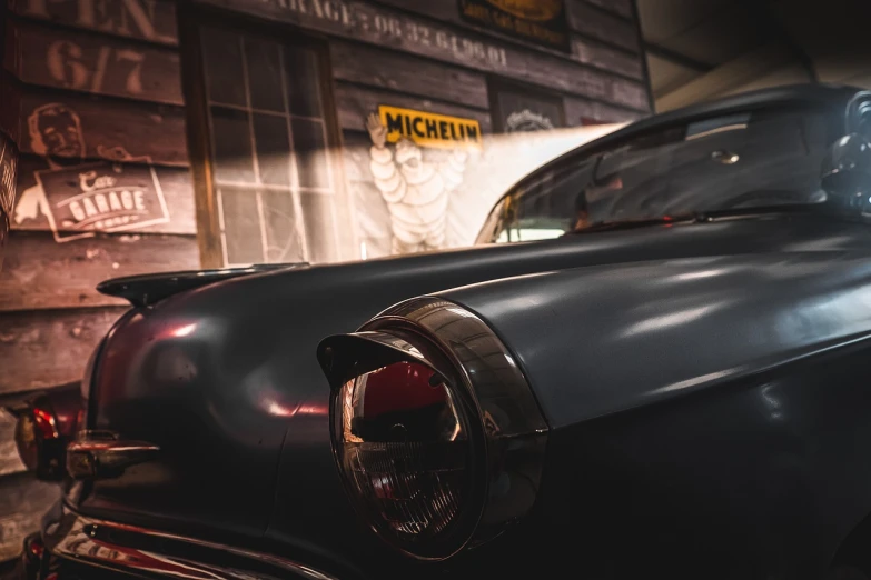 an old car is parked in a garage, by Micha Klein, pexels contest winner, photorealism, micro detail 4k, back lit, michelin star photography, 1957 chevrolet bel air