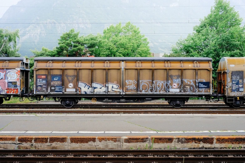 a train with graffiti on the side of it, unsplash, graffiti, trending on juxtapoz magazine, cart, flat color, photography hyperrealism