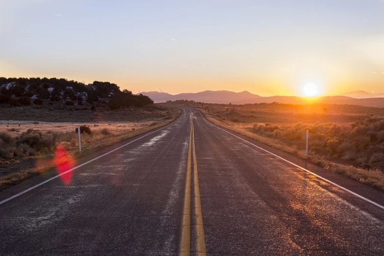 a long empty road with the sun setting in the distance, a picture, realism, header, new mexico, background image, technical