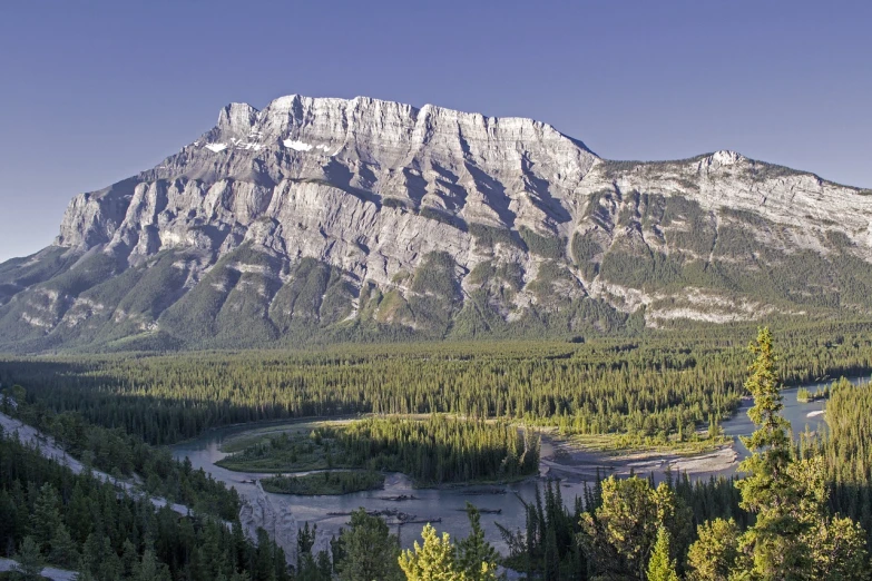 a view of a mountain with a river running through it, by Brigette Barrager, shutterstock, banff national park, iso 1 0 0 wide view, overlooking a valley with trees, erosion