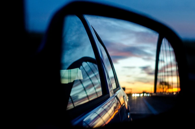 the reflection of a car in a rear view mirror, a picture, by Thomas Häfner, unsplash, realism, at dusk!, profile perspective, portra 8 0 0 ”, over the horizon