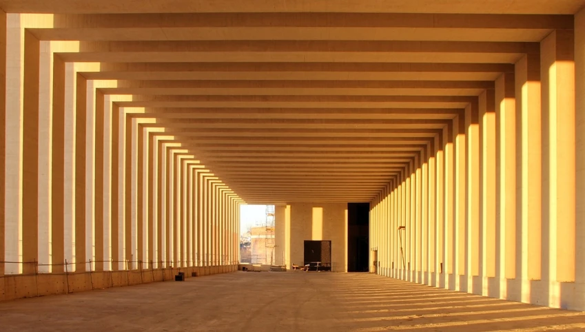 the sun shines through the columns of a building, inspired by David Chipperfield, flickr, zaragoza gilberto soren, walkway, built in the egyptian desert, jamel shabbaz