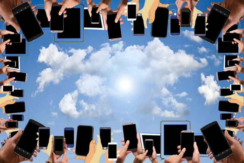 a group of people holding up cell phones in a circle, shutterstock, loots of clouds, on a bright day, computer, background image