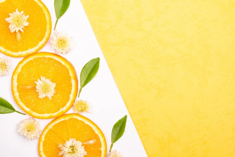 orange slices with leaves and flowers on a yellow background, trending on pixabay, minimalism, background image, on white paper, perfume, discovered photo