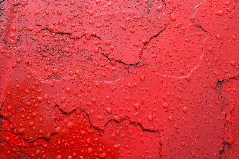 a red metal surface with water droplets on it, a stock photo, inspired by Lucio Fontana, pexels, large cracks, car paint, water - logged, bangalore